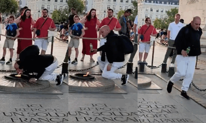 Si accende una sigaretta con la fiamma della tomba del milite ignoto a Parigi
